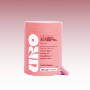 Frasco rosa de URO Vaginal Probiotic de OPositiv Health con dos capsulas de color rosa al lado sobre fondo degradado